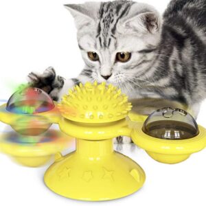 yellow cat toy spins around with white black kitten playing