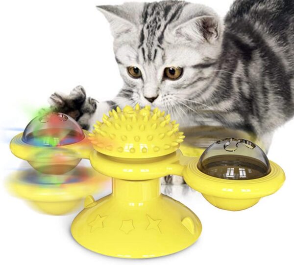 yellow cat toy spins around with white black kitten playing